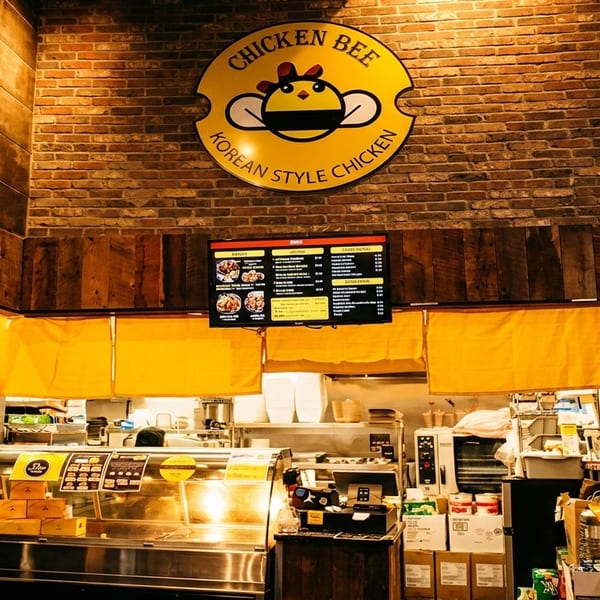 Chicken Bee Korean Style Chicken restaurant interior with a menu board and service counter.